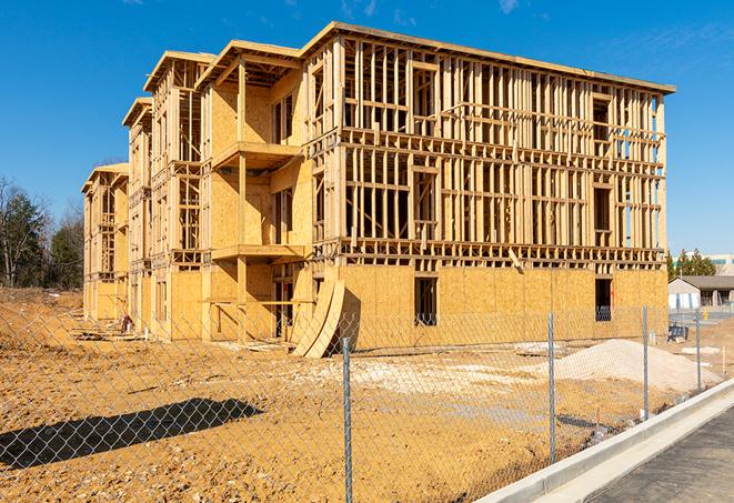 a close-up of temporary chain link fences enclosing a job site, signaling progress in the project's development in Clarkston